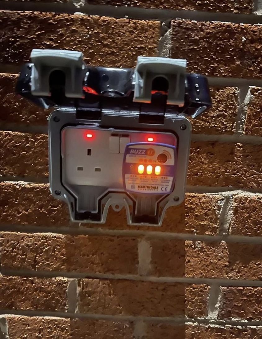 Outdoor socket with a socket tester plugged in